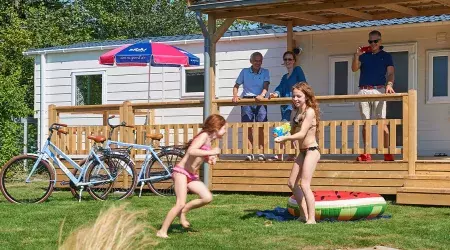 Famille devant mobil home au camping de Oase